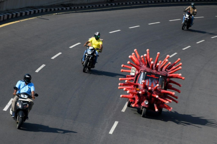 A health worker drives an auto-rickshaw decorated as a coronavirus model to raise awareness about the pandemic in Chennai, India