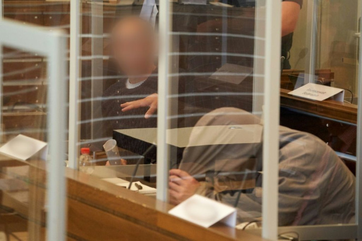 Syrian defendants Anwar Raslan (L), 57, and Eyad al-Gharib (R), 43, wait in the courtroom before the start of an unprecedented trial on state-sponsored torture in Syria, at court in Koblenz, western Germany