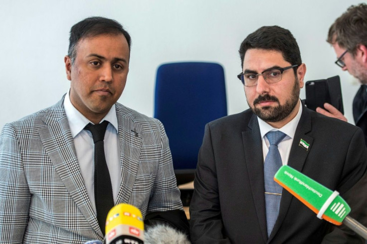 (LtoR) Attorney Khubaib-Ali and co-plaintiff Mohamad Alshaar answer journalists' questions outside the courtroom during a break in a trial against two Syrian defendants accused of state-sponsored torture in Syria