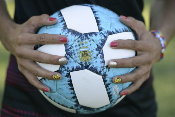 Mara Gomez poses with a ball before the start of a training session with her team, Villa San Carlos