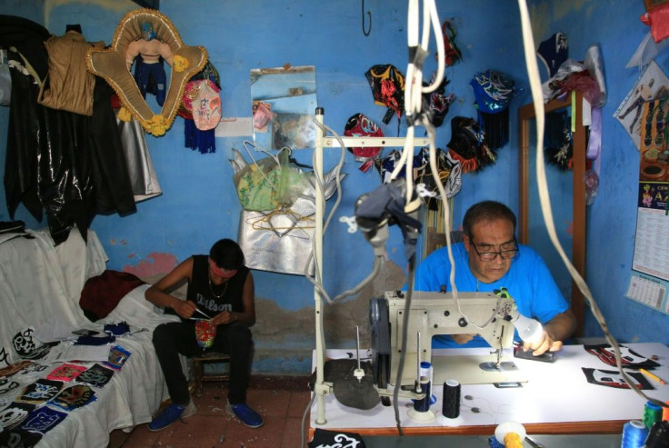 Jose Isaias Huerta and his nephew Saul work on handmade lucha libre masks