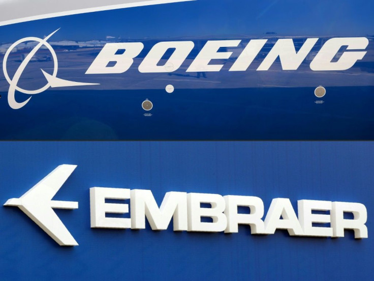 This combination of file pictures created on December 21, 2017 shows the Boeing logo on the fuselage of a Boeing 787-10 Dreamliner at Le Bourget Airport on June 18, 2017, and the logo of Brazil's Embraer at Le Bourget Airport, on June 23, 2013