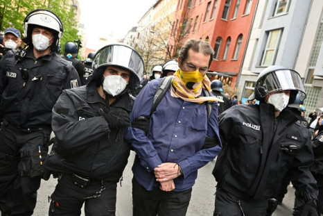 Police remove a demonstrator during he anti-confinement protest in Berlin