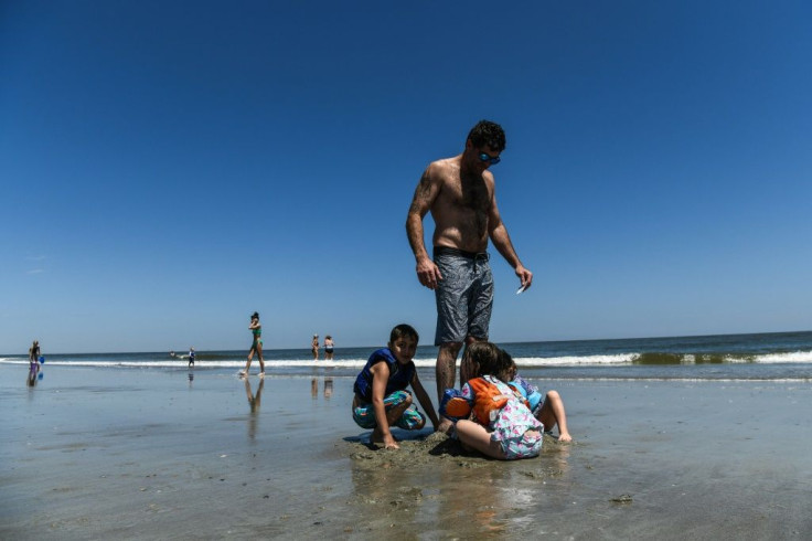 Children play with their father on Tybee Island, Georgia, a laid-back tourist destination on the Atlantic coast