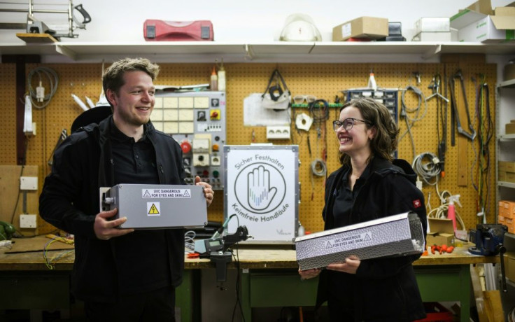 Co-founder Katharina Obladen (R) and student Leon Rottmann test out modules -- the idea to use UV light boxes was inspired by New York's use of ultraviolet radiation to sterilise drinking water