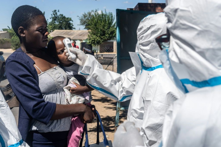 Medical personnel check temperatures of patients visiting Mpilo Hospital in Bulawayo, Zimbabwe