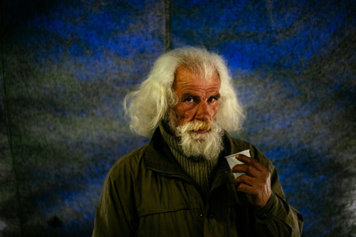 A homeless man in Moscow gets a meal at s has a meal at the "Rescue Hangar" during the COVID-19 coronavirus lockdown