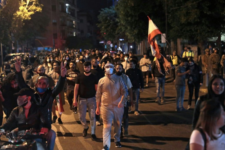 Lebanese demonstrators walk through the streets of the capital Beirut as anger over a spiralling economic crisis re-energised a months-old anti-government movement
