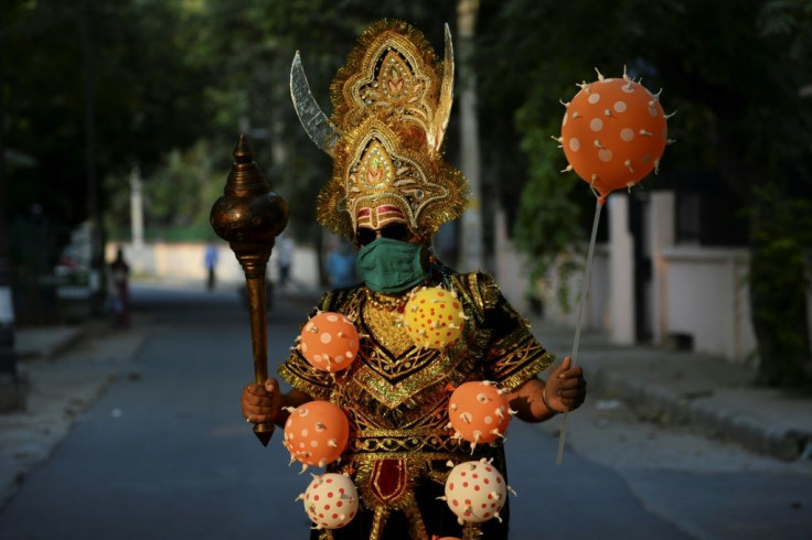 A man dressed as 'Yamraj', the Hindu mythical angel of death, campaigns to raise awareness on the importance to stay home and maintain social distancing during an event organised by Delhi police