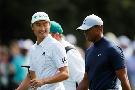 China's Li Haotong chats with Tiger Woods during the first round of the US Masters at Augusta last year. Woods went on to win his 15th major at the event