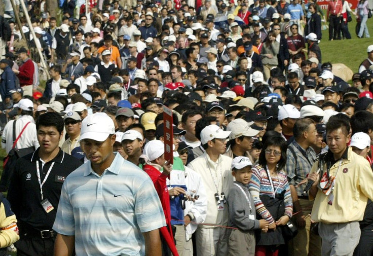 Tiger Woods is followed by massive crowds at the inaugural HSBC Champions in Shanghai in 2005