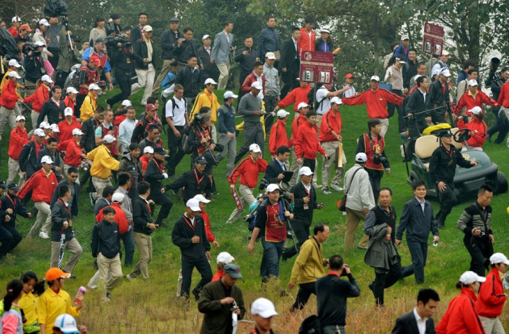 Tiger Woods and Rory McIlroy are surrounded by fans invading the course during their chaotic "Duel at Jinsha Lake" in 2012