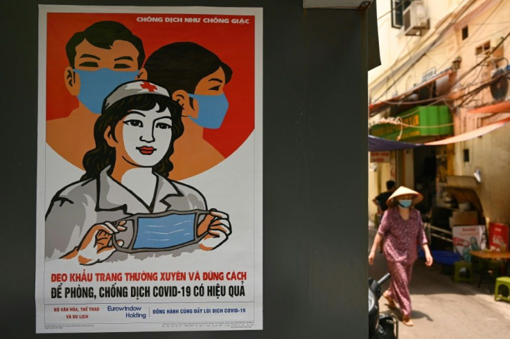 A poster in the style of Vietnamese communist propaganda art warns against the spread of coronavirus in Hanoi