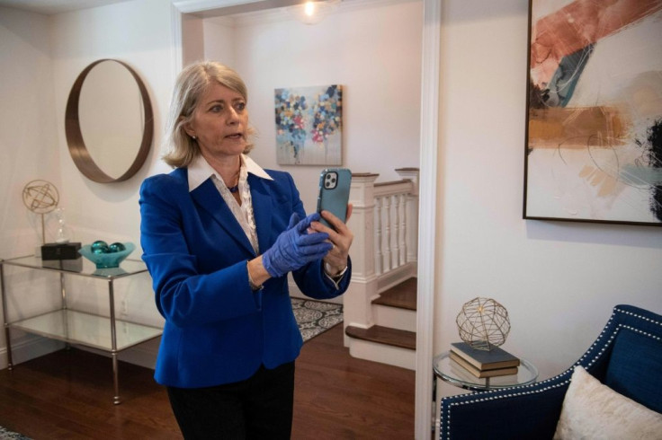 Real estate agent Dana Scanlon conducts a virtual tour of a house with a client over Facetime in Washington, DC