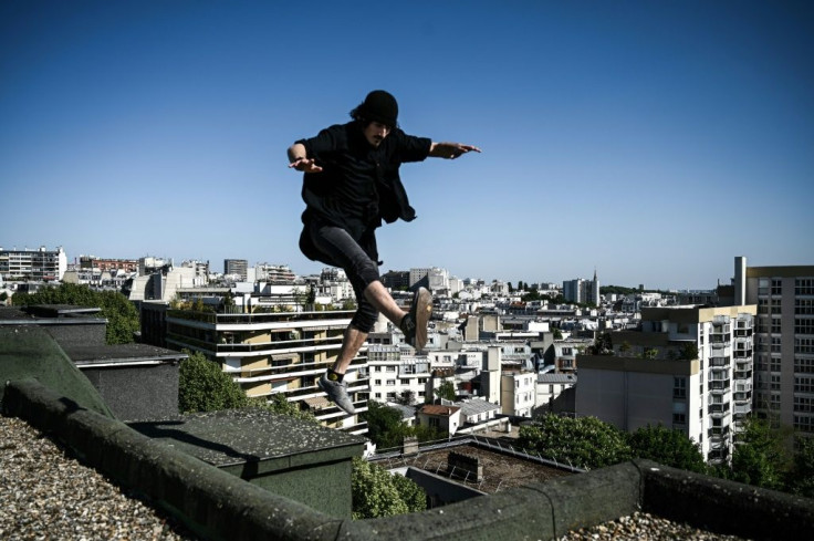 Between pavement and stars: freerunner Simon Nogueira flits across the roof tops of Paris