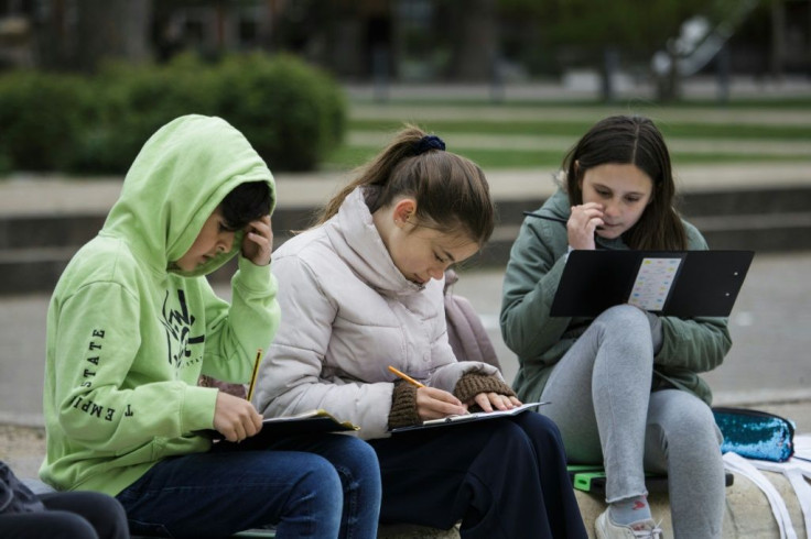 Pupils of the Norrebro Park primary school have lessons outside in a nearby park in Copenhagen, Denmark