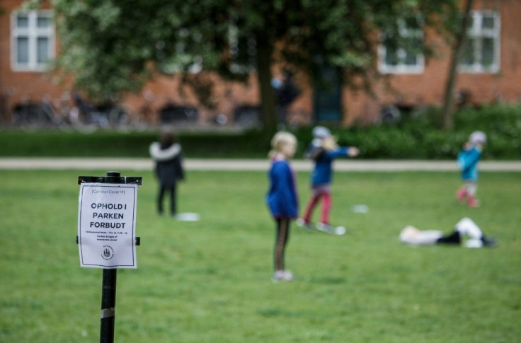 A sign informs the public they not welcome in the park as pupils of the Norrebro Park primary school spead time outside for lessons in Copenhagen, Denmark