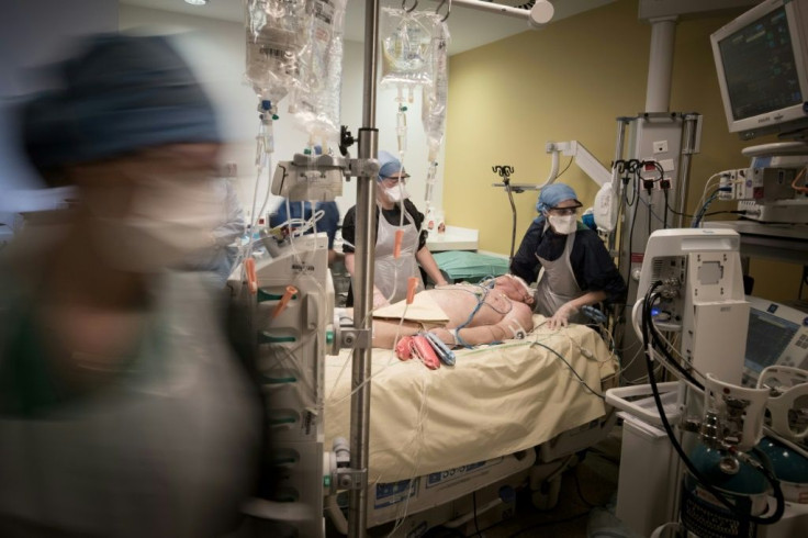 Doctors and nurses tending to a COVID-19 patient in the intensive care unit at the Lariboisiere hospital in Paris