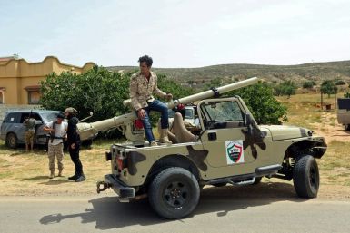 Fighters for Libya's UN-recognised Government of National Accord (GNA) gather at a position near the town of Garabulli, some 70km east of the capital Tripoli, amid battles with forces loyal to the Libyan strongman Khalifa Haftar earlier this month