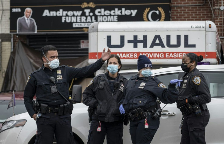 Police stand in front of a funeral home in Brooklyn on April 30, 2020 after dozens of bodies were found decomposing in trucks