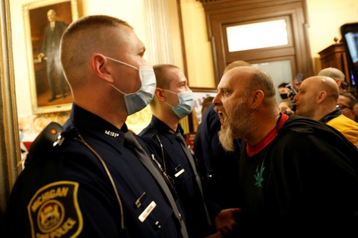 Protesters demanding an end to coronavirus lockdown orders tried to enter the House Chamber in the Michigan state capitol on April 30, 2020, but were blocked by state police