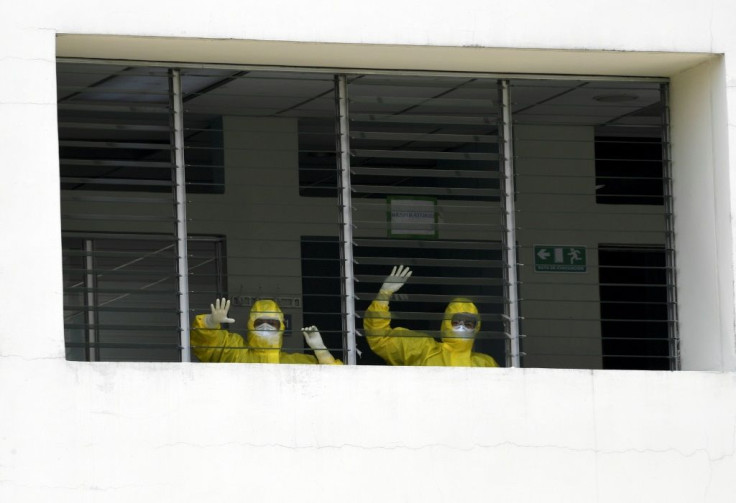 Health workers celebrate as they watch a 16-year-old patient who recovered from COVID-19 leave hospital in Santa Tecla, El Salvador