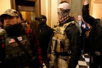 Armed protestors try to enter the chamber of the Michigan State Capitol in Lansing during a rally organized by Michigan United for Liberty demanding the reopening of businesses