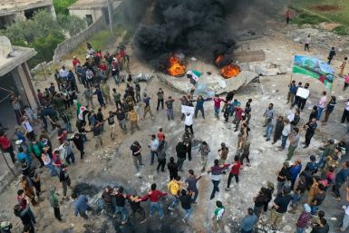 A drone images shows Syrian demonstrators gathering during a protest in the village of Maaret al-Naasan in Syria's Idlib province to protests against a reported attack by Hayat Tahrir al-Sham, an alliance led by a former Al-Qaeda affiliate
