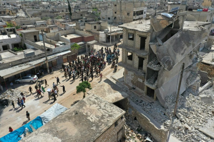 A drone images shows Syrian demonstrators gatheringin the village of Maaret al-Naasan in Syria's Idlib province on May 1, 2020, to protest against a reported attack by Hayat Tahrir al-Sham on a protest the previous day