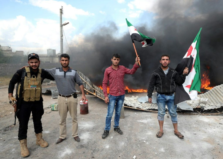 Syrian demonstrators gather on May 1, 2020, to protest against a reported attack by Hayat Tahrir al-Sham, an alliance led by a former Al-Qaeda affiliate, on a protest the previous day