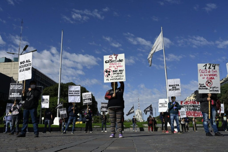 Members of Polo Obrero social organization march towards Plaza de Mayo square holding banners during a May Day demonstration in Buenos Aires, Argentina