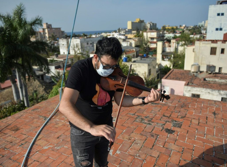 Cuban violinist William Roblejo rehearses on the rooftop of his house in Havana