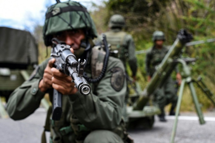 The Venezuelan military is undertaking a massive air, sea and land search for remnants of attackers the government described as "mercenaries"