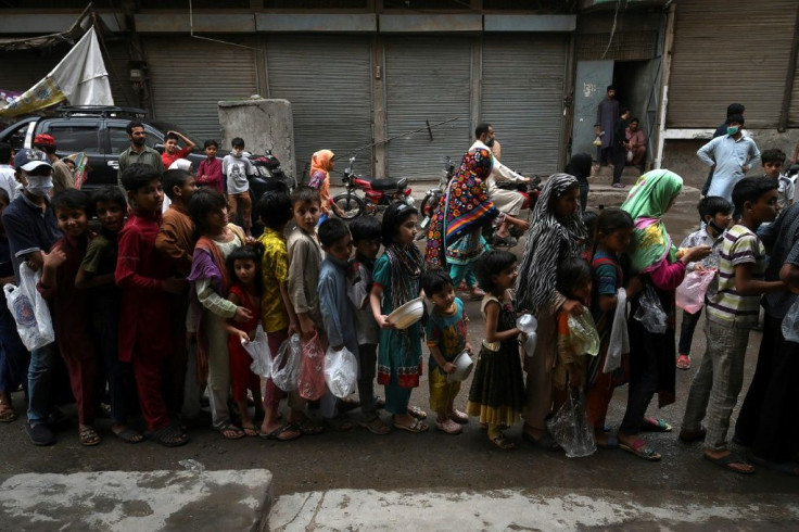 Children queue for free food in Lahore, Pakistan, during a government-imposed nationwide coronavirus lockdown