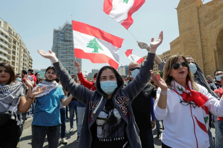 Lebanese anti-government protesters, some wearing protective masks amid the COVID-19 pandemic, demonstrate in downtown Beirut against Lebanon's worst financial crisis in decades on May 1