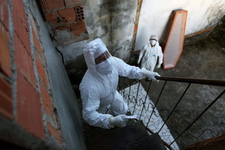 Municipal workers arrive to pick up the body of a person suspected of having died from COVID-19, from his home in Manaus, in the Brazilian state of Amazonas