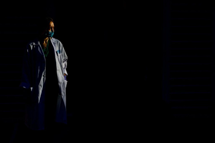 Maria Luisa Prado walks outside the Madrid healthcare centre which had been overwhelmed with COVID-19 patients