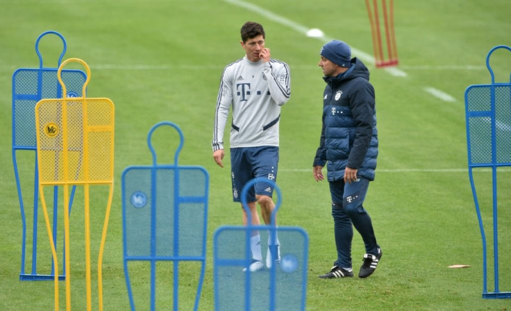 Bayern Munich's headcoach Hansi Flick (R) and Bayern Munich's Polish striker Robert Lewandowski  during a training session at the team's training grounds in Munich