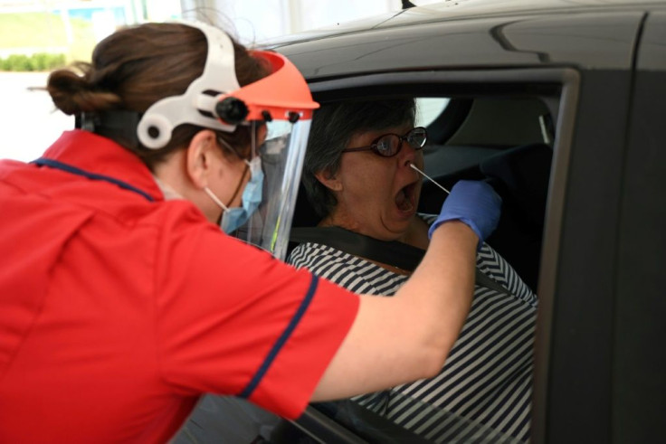 Clinical staff test a key worker for the novel coronavirus at the Royal Papworth Hospital in Britain, which has suffered a rising coronavirus death toll