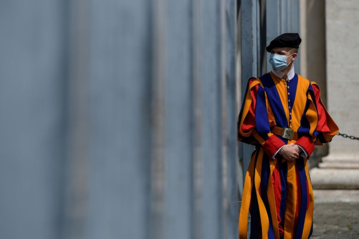 On guard: The elite Swiss Guard are wearing face masks as they patrol the Vatican