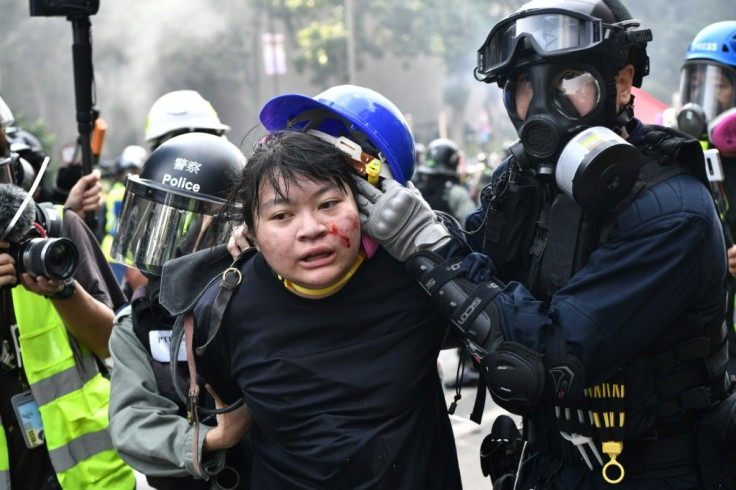Protesters are detained by police near the Hong Kong Polytechnic University in November 2019
