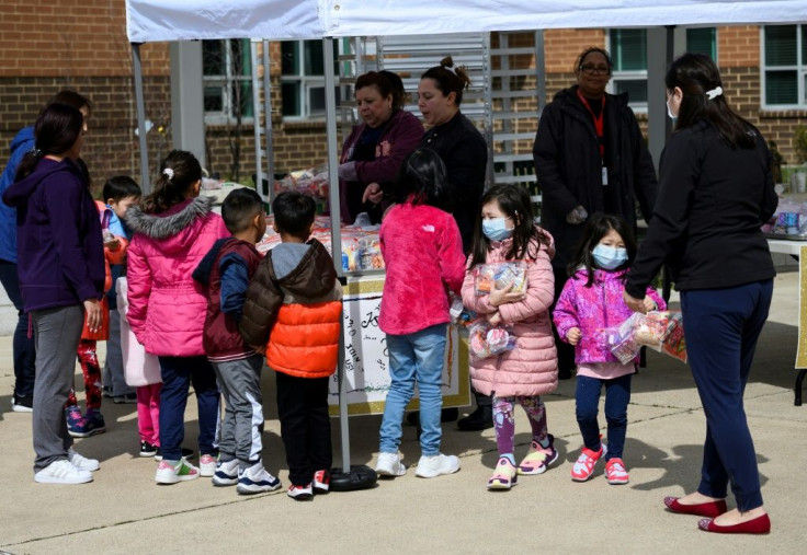 Children pick up free lunch in Arlington, Virginia on March 16, 2020, after schools closed due to coronavirus. Disrupted school lunch programs could be a factor in alarming rises in hunger among US children since the outbreak began, the study says