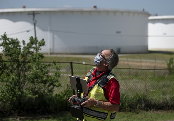 Dale Parrish's clients depend on him for the latest data on how much oil is in these tanks
