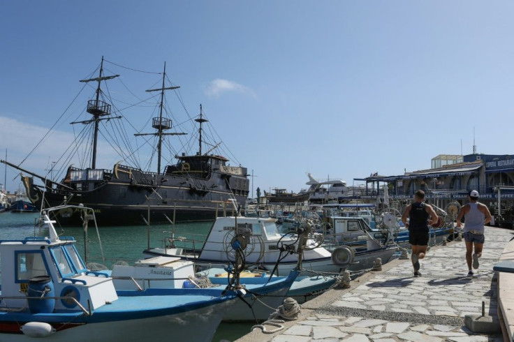 Men jogging along the harbour front in Ayia Napa this week