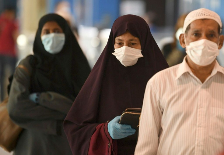 Indian nationals gather at the Dubai International Airport before leaving the Gulf Emirate on a flight back to their country, on May 7, 2020