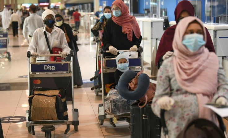 Indian nationals gather at the Dubai International Airport before leaving the Gulf Emirate on a flight back to their country, on May 7, 2020