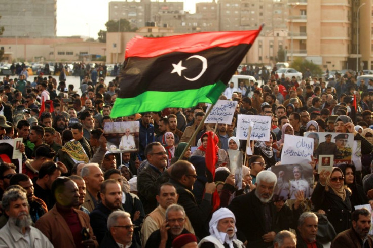 Supporters of Libyan military strongman Khalifa Haftar wave a national flag in a February 2020 demonstration in Benghazi