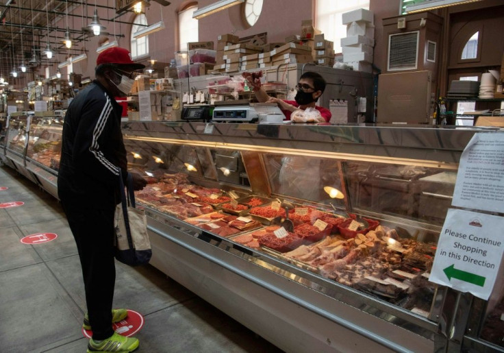 A man purchases meat at in Washington, DC, on May 5, 2020. US slaughterhouses have emerged as COVID-19 outbreak hotspots in several states, providing a window of opportunity for plant-based protein