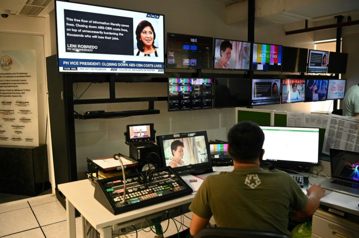 Employees of ABS-CBN work in the editing booth at the station headquarters in Manila on May 6, 2020 before it was forced to shut down