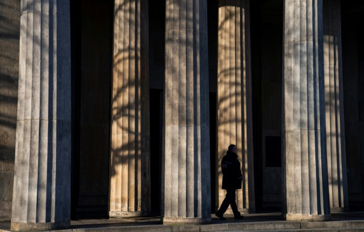 A guard walks past the columns of a memorial in Berlin that will figure in VE day ceremonies